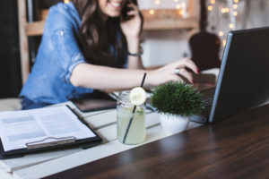 Beautiful hipster woman using laptop at modern office