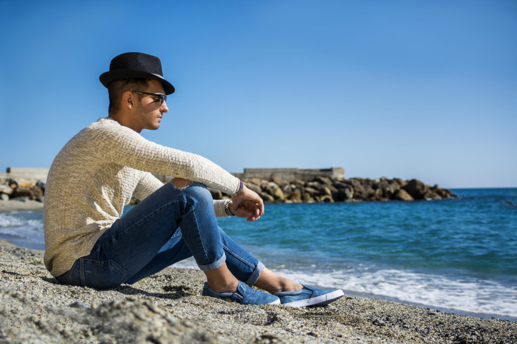 Young Man on a Beach in Sunny Summer Day