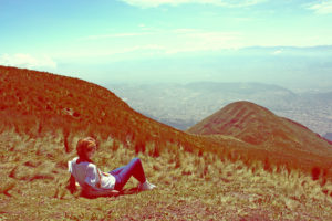 Girl is sitting on a mountain top, Ecuador